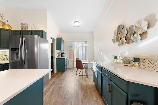 kitchen with visible vents, tasteful backsplash, light wood-style floors, and stainless steel refrigerator with ice dispenser