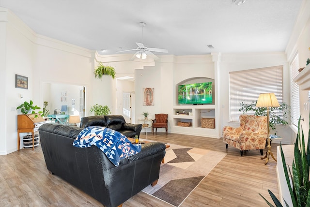 living room with light wood-type flooring, visible vents, and ceiling fan