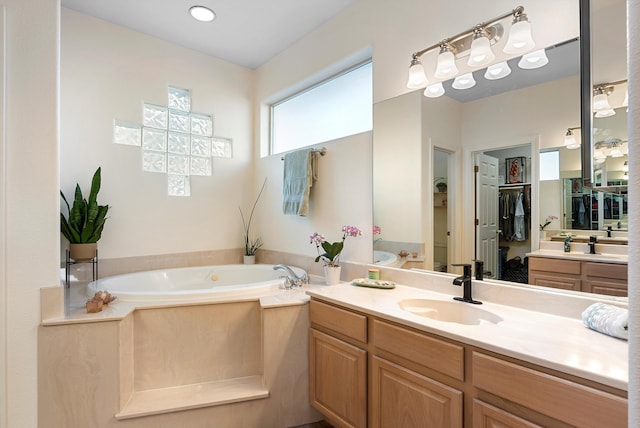 full bath with a bath and vanity