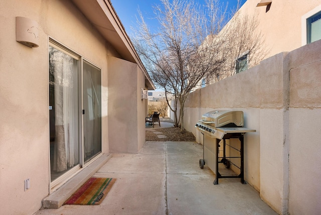 view of patio / terrace featuring fence and a grill