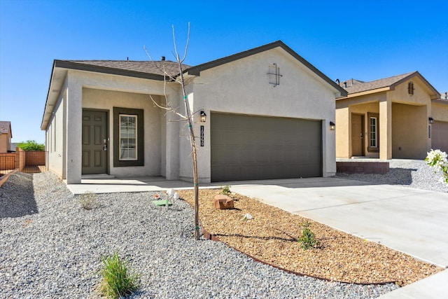 single story home with an attached garage, driveway, fence, and stucco siding