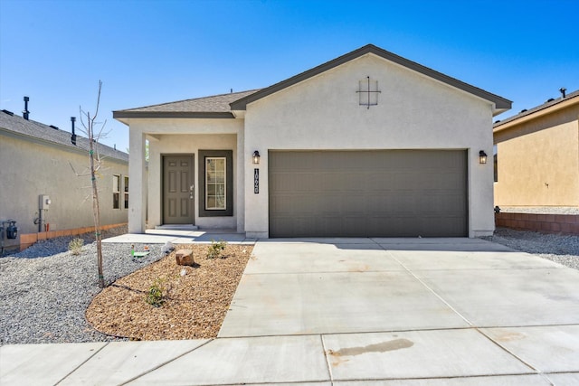 view of front of home featuring an attached garage, roof with shingles, concrete driveway, and stucco siding