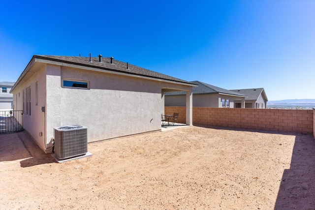 back of property featuring a patio, fence, cooling unit, and stucco siding