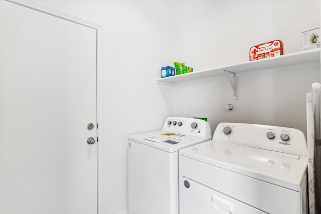 laundry room with laundry area and washing machine and clothes dryer