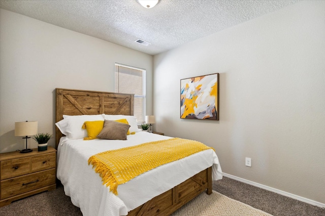 bedroom with baseboards, a textured ceiling, visible vents, and carpet flooring