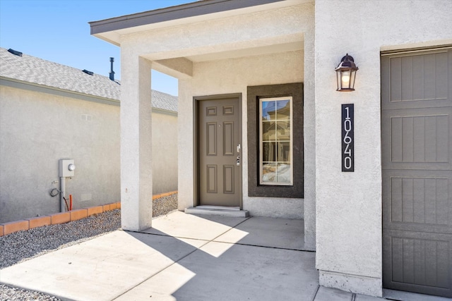 view of exterior entry with stucco siding