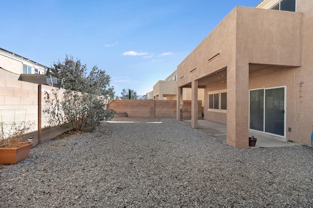 view of yard with a fenced backyard and a patio