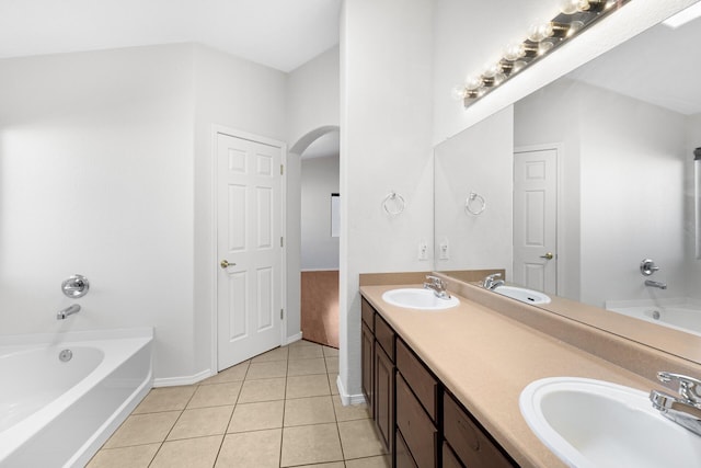 full bathroom with tile patterned flooring, a bathtub, and a sink