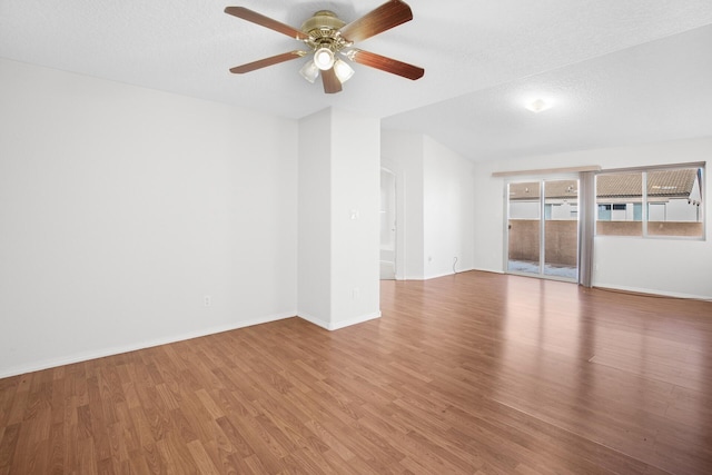 unfurnished room featuring ceiling fan, a textured ceiling, baseboards, and wood finished floors