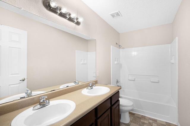 bathroom featuring visible vents, a sink, a textured ceiling, and toilet