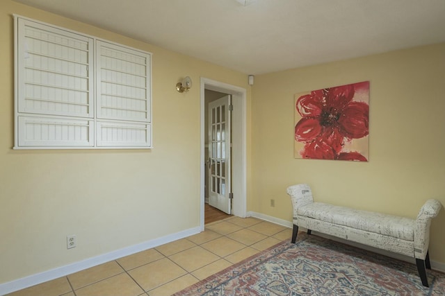 living area with light tile patterned floors and baseboards