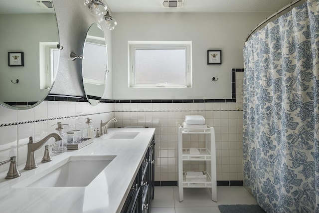 bathroom with a sink, visible vents, and tile patterned floors