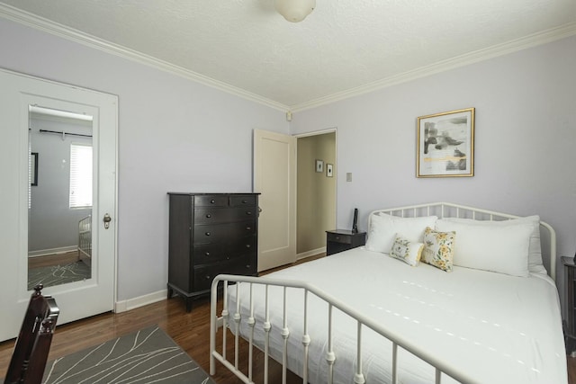 bedroom with dark wood-style floors, crown molding, a textured ceiling, and baseboards