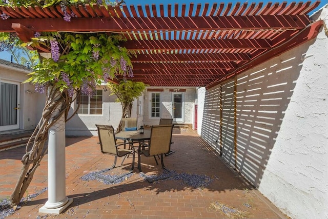 view of patio featuring outdoor dining area and a pergola