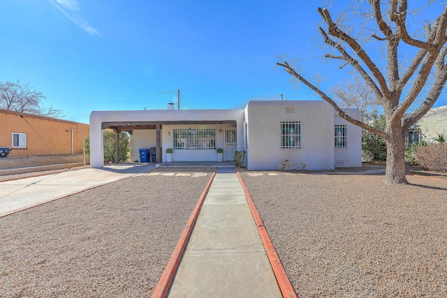 pueblo-style home with stucco siding