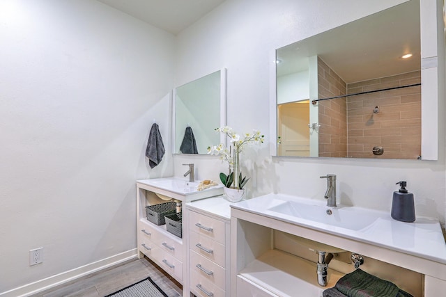 bathroom with vanity, baseboards, and wood finished floors