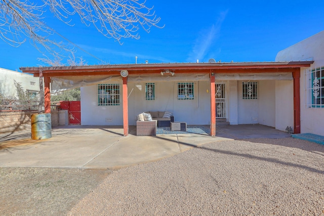 back of house with a patio and outdoor lounge area