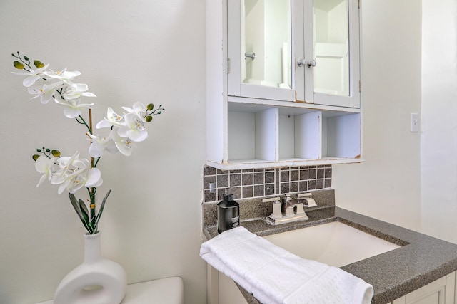 bathroom featuring backsplash and a sink