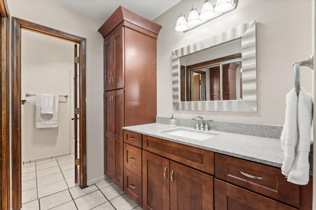 bathroom with tile patterned flooring and vanity