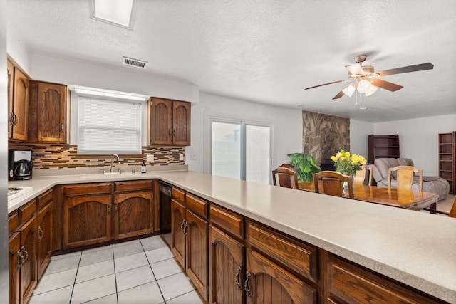 kitchen with light countertops, visible vents, plenty of natural light, and backsplash