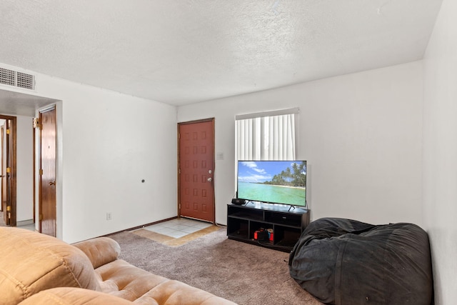 carpeted living room featuring visible vents and a textured ceiling