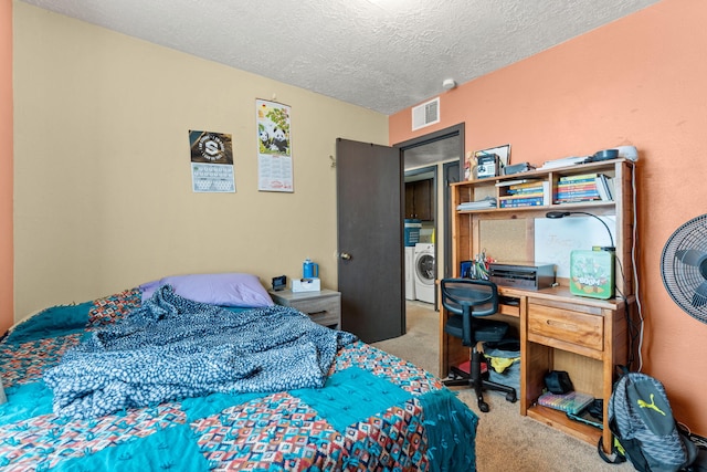 bedroom featuring a textured ceiling, washer / clothes dryer, carpet, and visible vents