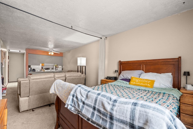 carpeted bedroom with a textured ceiling and ceiling fan