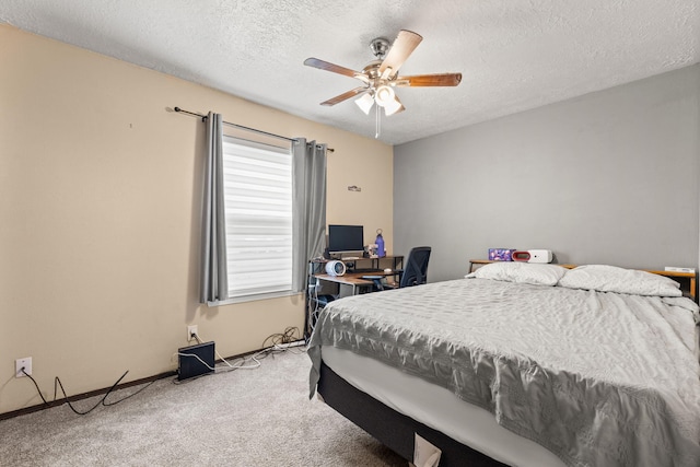 carpeted bedroom with a textured ceiling and ceiling fan