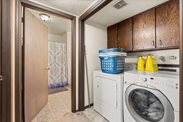 laundry area with visible vents, a textured ceiling, independent washer and dryer, and cabinet space