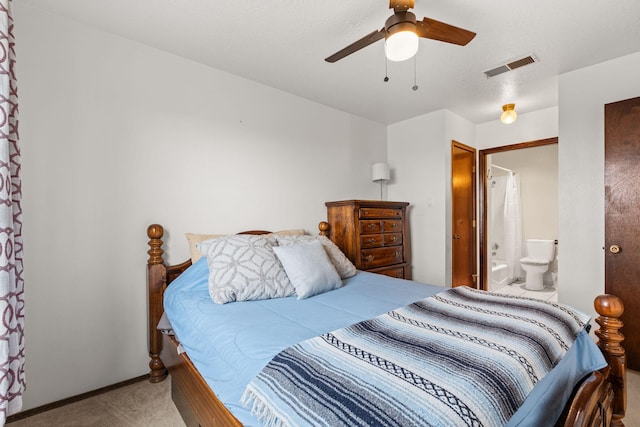 carpeted bedroom featuring connected bathroom, visible vents, and ceiling fan