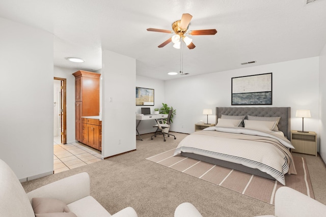 bedroom featuring a ceiling fan, light colored carpet, visible vents, and baseboards