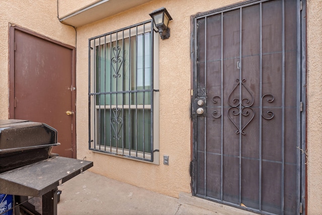 property entrance with stucco siding