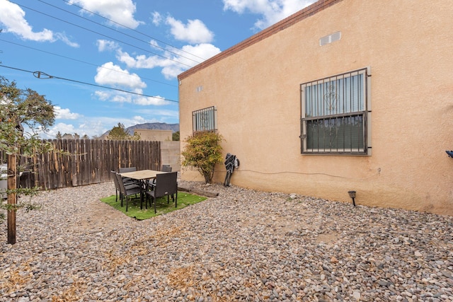 view of home's exterior with fence and stucco siding