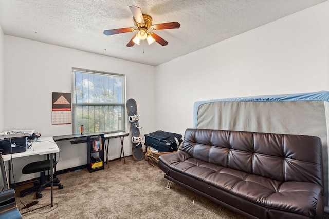 carpeted office space with a textured ceiling and a ceiling fan