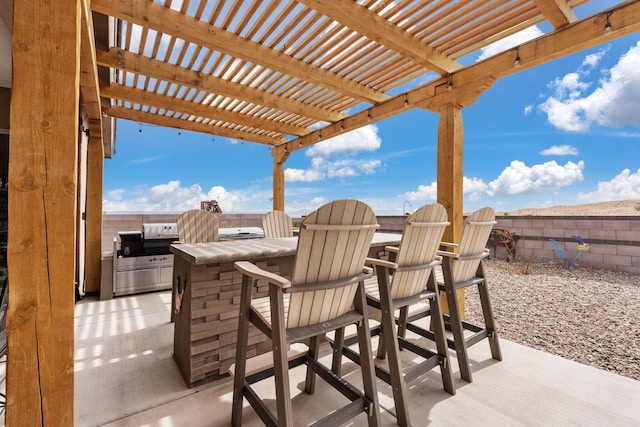 view of patio with outdoor dry bar, an outdoor kitchen, a pergola, and fence