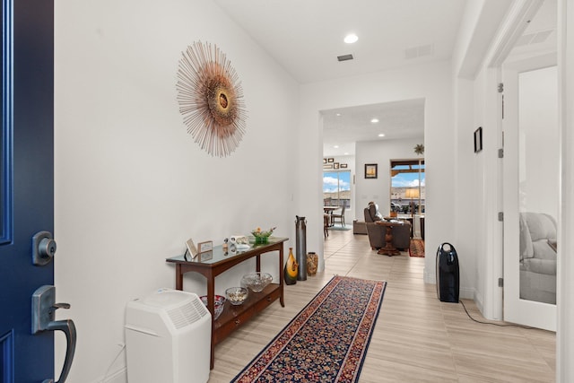 hall featuring recessed lighting, visible vents, and baseboards