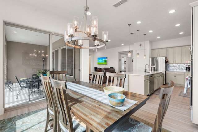 dining area with a chandelier, visible vents, recessed lighting, and light wood-type flooring