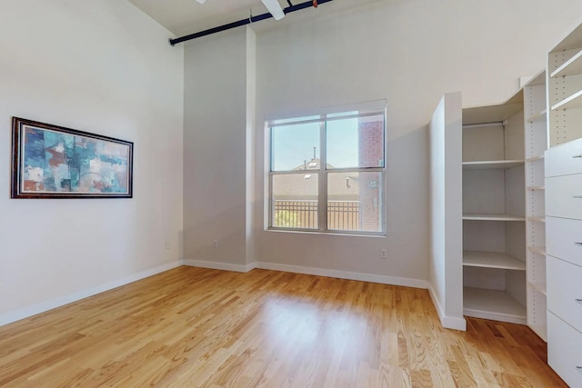 interior space featuring light wood-style flooring and baseboards