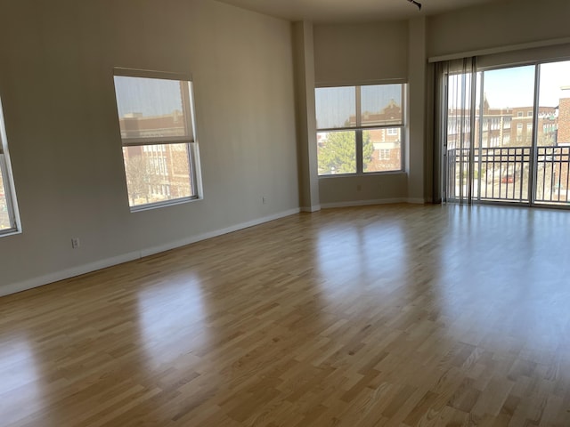 unfurnished room with wood finished floors and baseboards