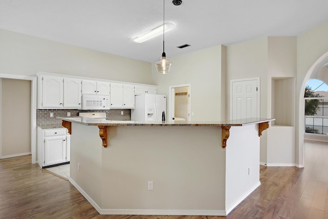 kitchen featuring white appliances, white cabinetry, and light wood-style floors