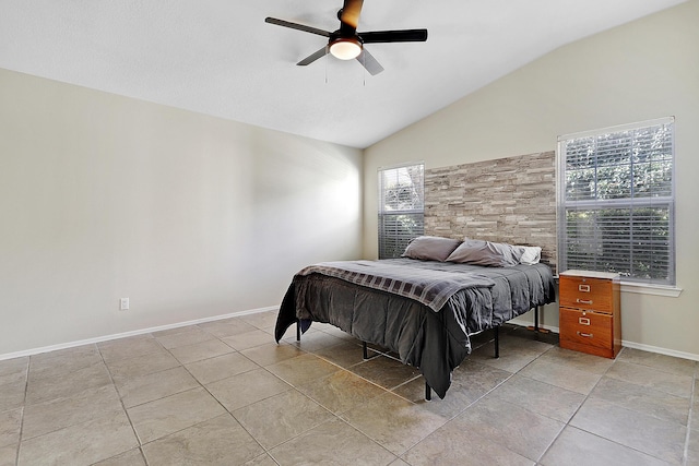 bedroom with lofted ceiling, ceiling fan, and baseboards