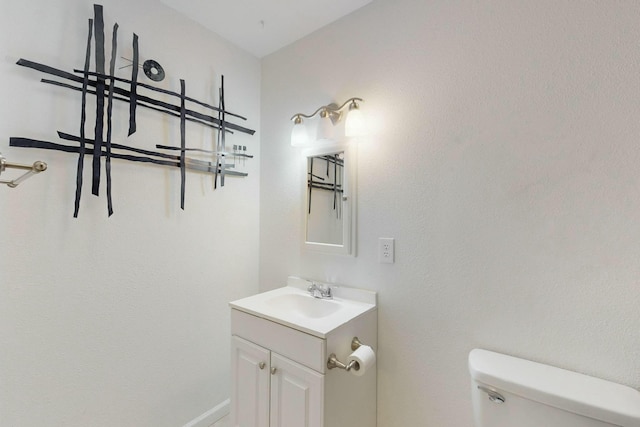 bathroom featuring toilet and vanity