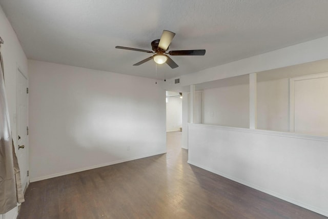 spare room featuring visible vents, baseboards, ceiling fan, wood finished floors, and a textured ceiling