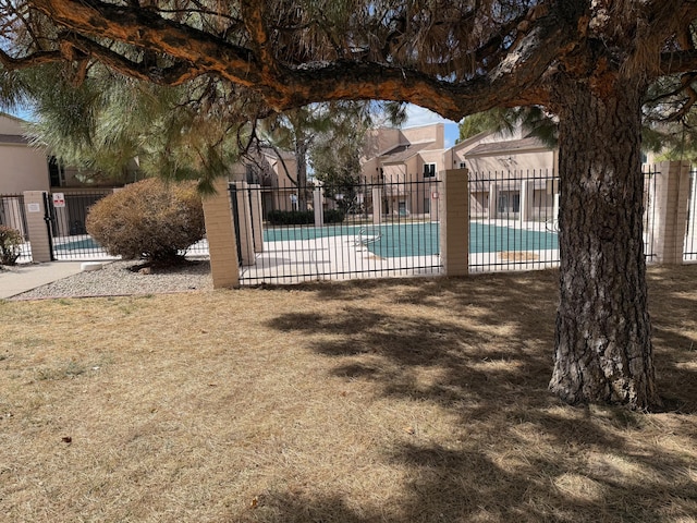 pool with a patio area and fence