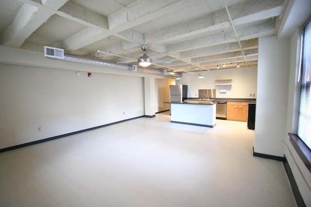 interior space with baseboards, visible vents, dark countertops, finished concrete floors, and stainless steel appliances