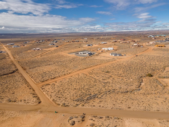 birds eye view of property with view of desert, a rural view, and a mountain view