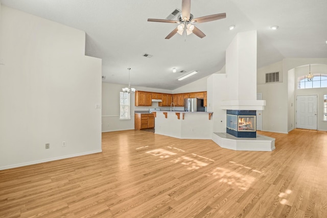 unfurnished living room with light wood-style floors, visible vents, and a wealth of natural light