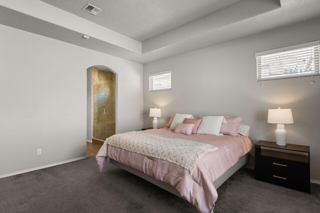 bedroom featuring visible vents, arched walkways, baseboards, carpet, and a textured ceiling