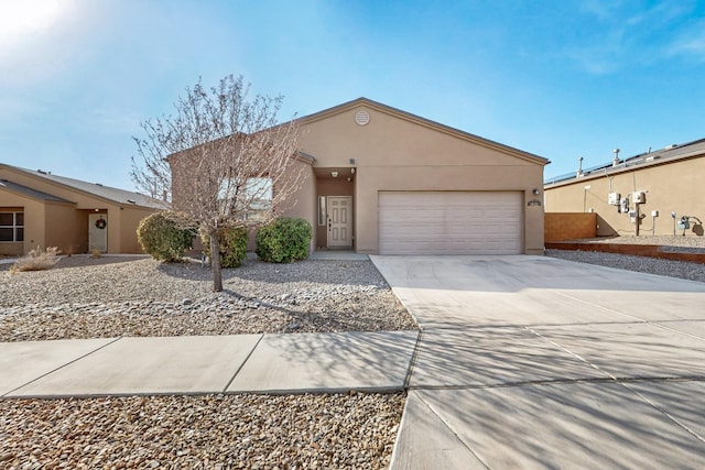 view of front of property with a garage, concrete driveway, and stucco siding