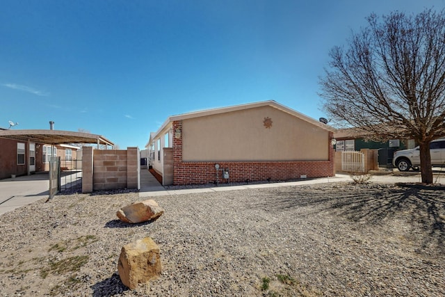 view of home's exterior with a gate and fence